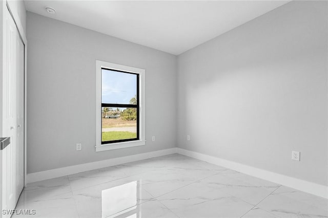 5215 7th St W, Lehigh Acres, FL 33971 - empty room with baseboards, light marble finish floors, and a smoke detector