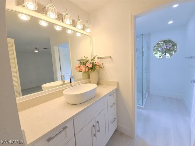 687 Grove Dr, Naples, FL 34120 - bathroom featuring a stall shower, vanity, and baseboards