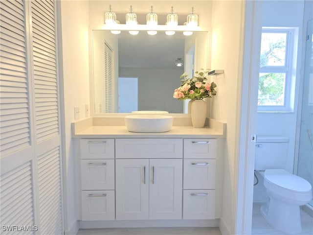 687 Grove Dr, Naples, FL 34120 - bathroom with toilet, vanity, a closet, and baseboards
