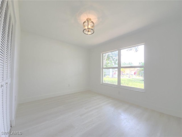 687 Grove Dr, Naples, FL 34120 - spare room with light wood-style floors and baseboards