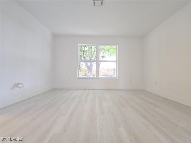 687 Grove Dr, Naples, FL 34120 - empty room with light wood-style flooring and baseboards