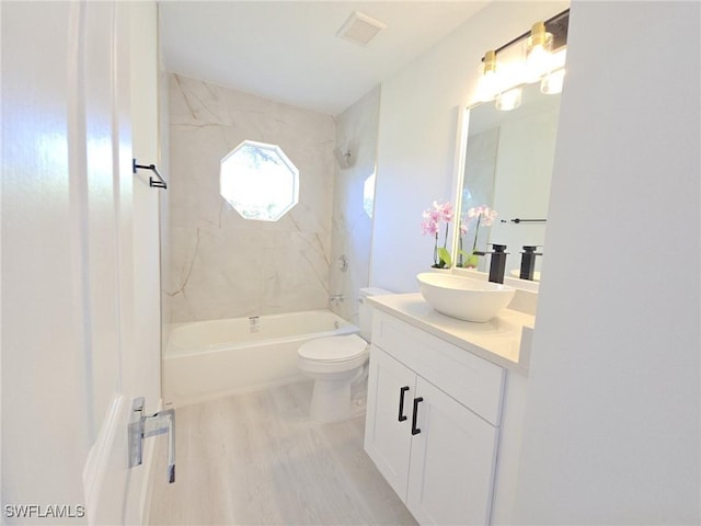 687 Grove Dr, Naples, FL 34120 - full bathroom with wood finished floors, vanity, bathtub / shower combination, and toilet
