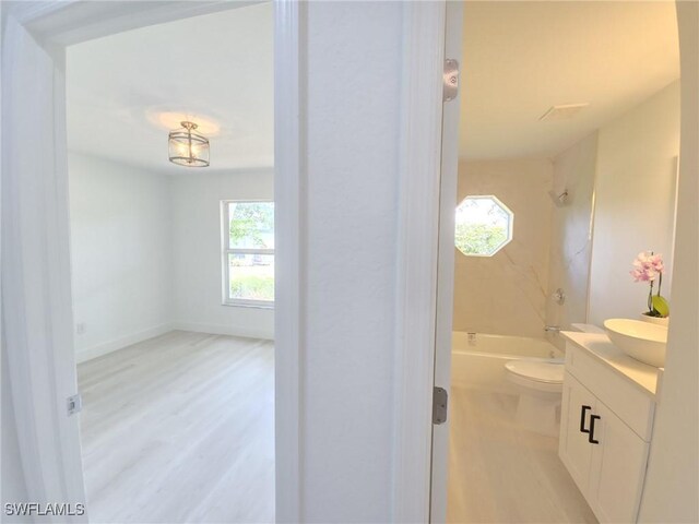 687 Grove Dr, Naples, FL 34120 - bathroom featuring healthy amount of natural light, vanity, toilet, and shower / bath combination