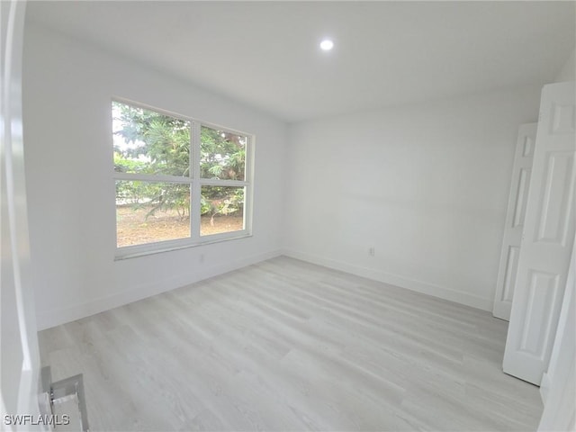 687 Grove Dr, Naples, FL 34120 - spare room featuring light wood-style flooring, baseboards, and recessed lighting