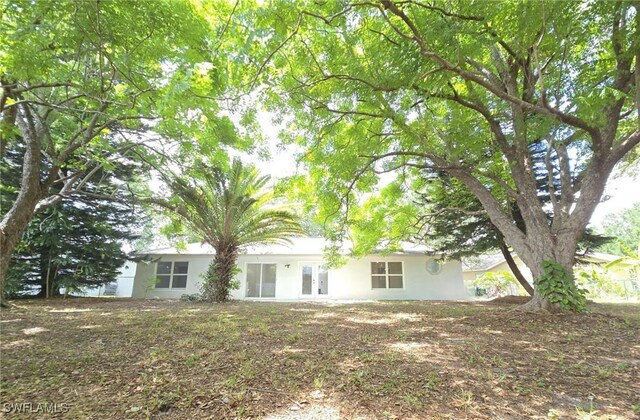 687 Grove Dr, Naples, FL 34120 - rear view of property with stucco siding