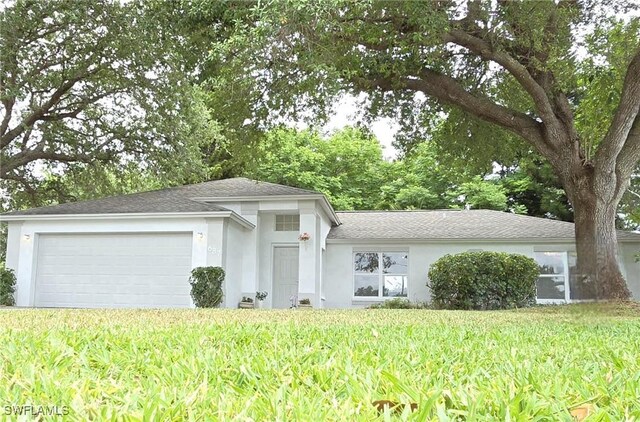 687 Grove Dr, Naples, FL 34120 - view of front of house with stucco siding, a garage, a front yard, and a shingled roof