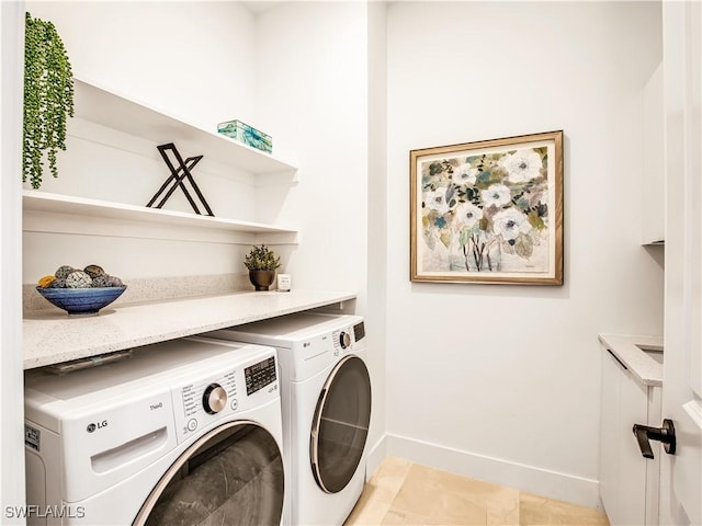 clothes washing area featuring washing machine and dryer and baseboards