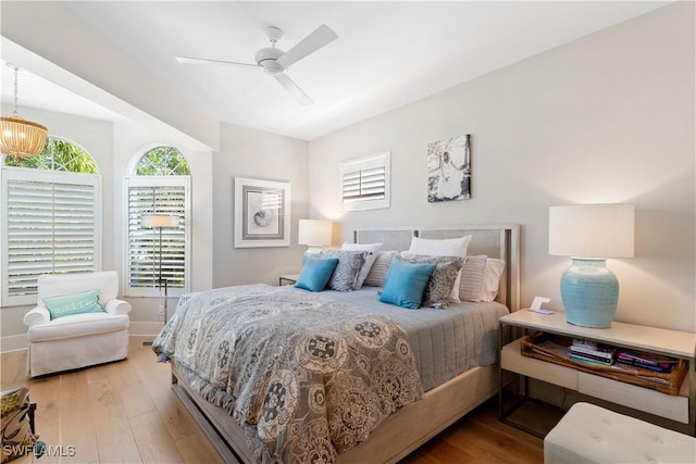 838 9th Ave S Unit 106, Naples, FL 34102 - bedroom featuring wood finished floors, baseboards, a chandelier, and a ceiling fan