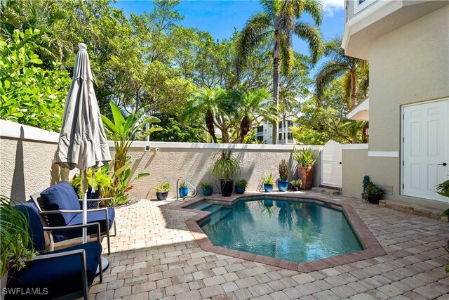838 9th Ave S Unit 106, Naples, FL 34102 - view of swimming pool featuring a patio and a fenced backyard