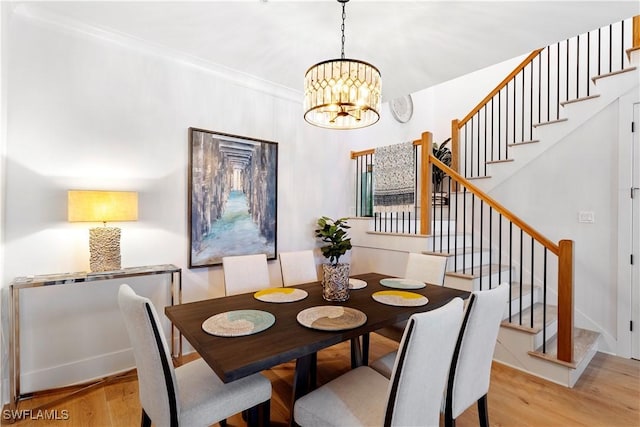 838 9th Ave S Unit 106, Naples, FL 34102 - dining area with stairway, wood finished floors, and a chandelier