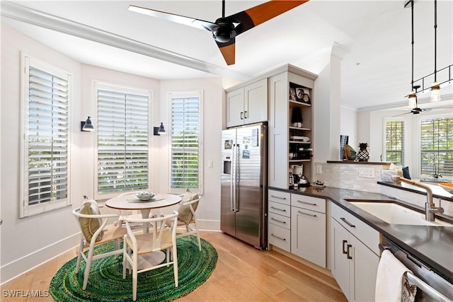 838 9th Ave S Unit 106, Naples, FL 34102 - kitchen with appliances with stainless steel finishes, a ceiling fan, a sink, baseboards, and light wood-style floors