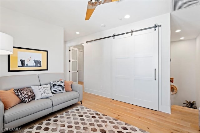 838 9th Ave S Unit 106, Naples, FL 34102 - living room featuring light wood-type flooring, a barn door, and recessed lighting