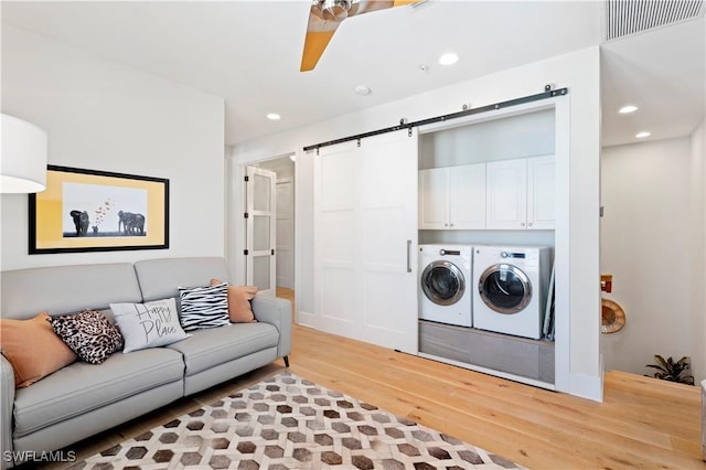 838 9th Ave S Unit 106, Naples, FL 34102 - living room with washing machine and dryer, light wood-type flooring, a barn door, recessed lighting, and ceiling fan