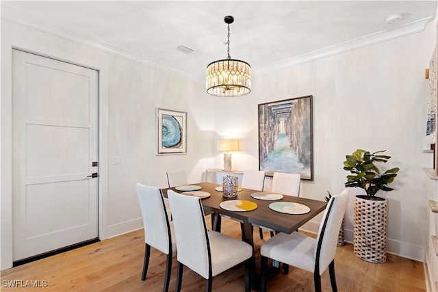 838 9th Ave S Unit 106, Naples, FL 34102 - dining space featuring a chandelier, light wood-style flooring, baseboards, and ornamental molding