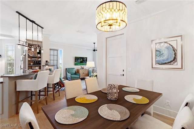 838 9th Ave S Unit 106, Naples, FL 34102 - dining area with crown molding, wood finished floors, a chandelier, and baseboards