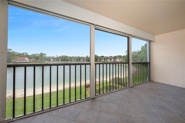 unfurnished sunroom with a water view