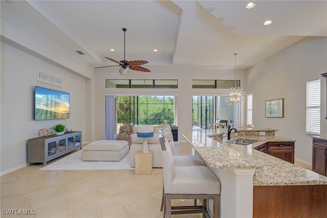 8336 Adelio Ln, Fort Myers, FL 33912 - kitchen with open floor plan, recessed lighting, a ceiling fan, light stone countertops, and a sink