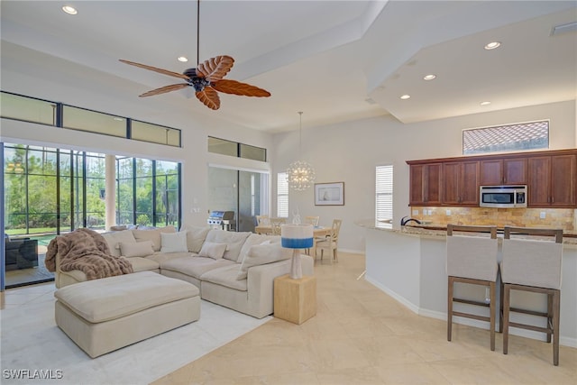 8336 Adelio Ln, Fort Myers, FL 33912 - living area featuring recessed lighting, a chandelier, a ceiling fan, baseboards, and a towering ceiling