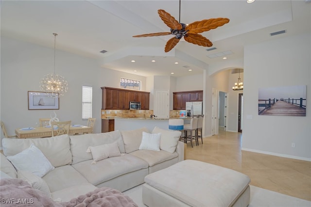 8336 Adelio Ln, Fort Myers, FL 33912 - living room featuring a chandelier, recessed lighting, arched walkways, a ceiling fan, and a towering ceiling