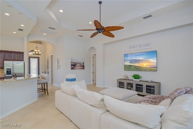 8336 Adelio Ln, Fort Myers, FL 33912 - living area featuring arched walkways, recessed lighting, a ceiling fan, a tray ceiling, and a chandelier