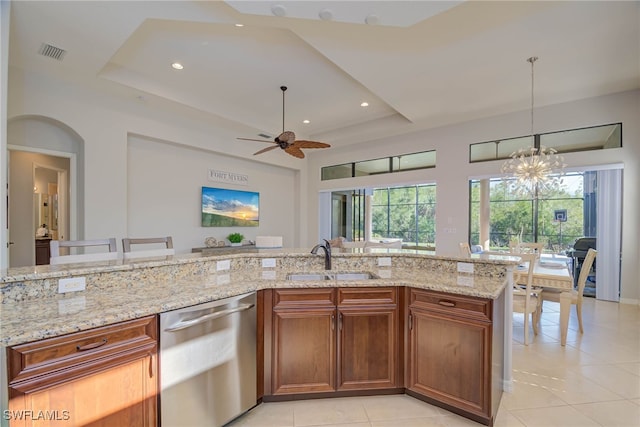 8336 Adelio Ln, Fort Myers, FL 33912 - kitchen with dishwasher, a sink, a raised ceiling, light tile patterned floors, and light stone countertops