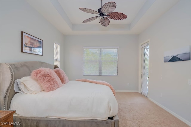 8336 Adelio Ln, Fort Myers, FL 33912 - bedroom with light carpet, a tray ceiling, baseboards, and ceiling fan