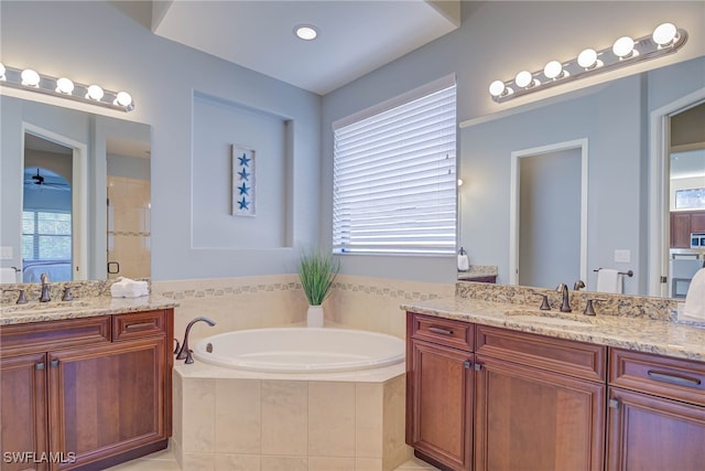 8336 Adelio Ln, Fort Myers, FL 33912 - full bathroom featuring a garden tub, two vanities, and a stall shower