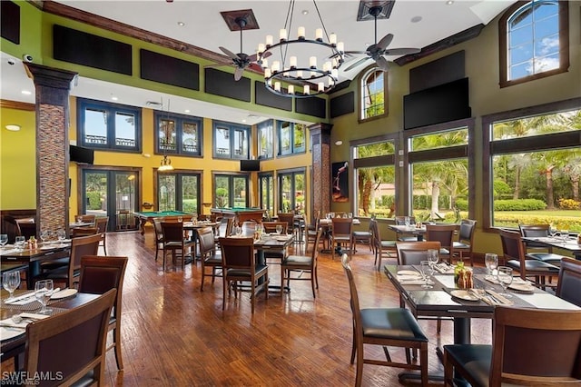 8336 Adelio Ln, Fort Myers, FL 33912 - dining room with hardwood / wood-style flooring, a high ceiling, and a chandelier