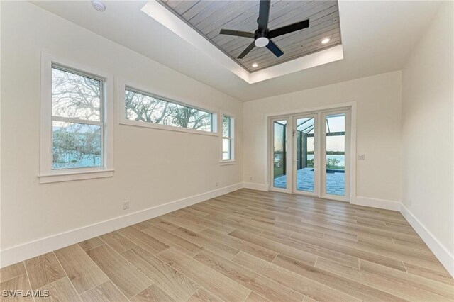 6100 Riverside Dr, Punta Gorda, FL 33982 - spare room with a tray ceiling, baseboards, light wood-style floors, ceiling fan, and recessed lighting