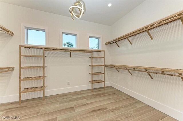 6100 Riverside Dr, Punta Gorda, FL 33982 - walk in closet with light wood finished floors