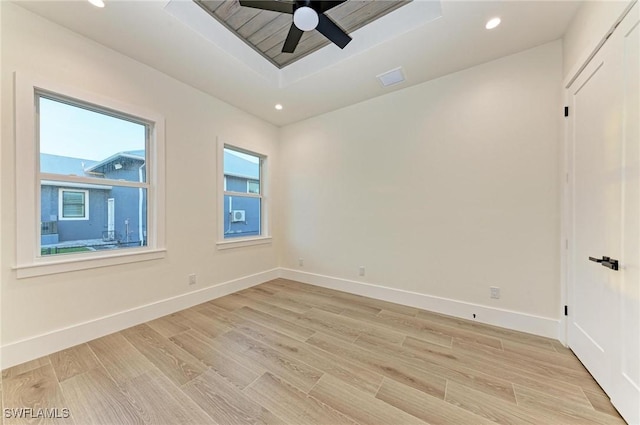 6100 Riverside Dr, Punta Gorda, FL 33982 - spare room featuring light wood-type flooring, ceiling fan, baseboards, recessed lighting, and a raised ceiling