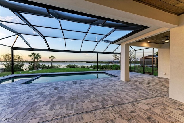 6100 Riverside Dr, Punta Gorda, FL 33982 - patio terrace at dusk featuring glass enclosure, an outdoor pool, and a water view