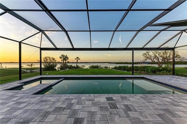6100 Riverside Dr, Punta Gorda, FL 33982 - pool at dusk featuring an outdoor pool, a patio area, a yard, and glass enclosure