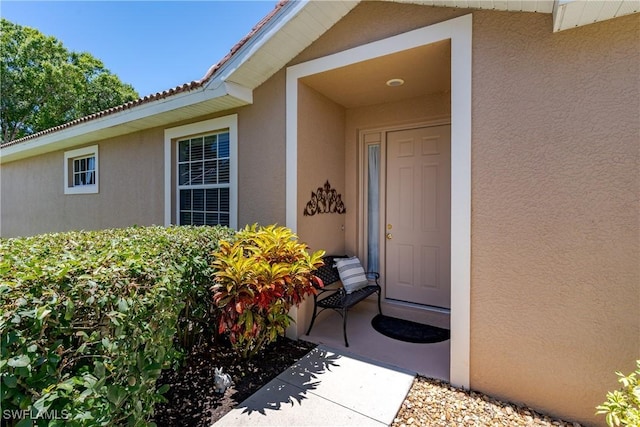6659 Castlelawn Pl Unit 21, Naples, FL 34113 - view of exterior entry featuring stucco siding