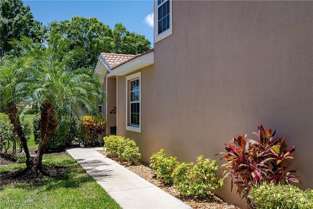 6659 Castlelawn Pl Unit 21, Naples, FL 34113 - entrance to property with stucco siding and a tile roof