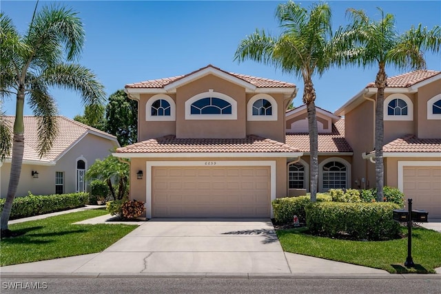 6659 Castlelawn Pl Unit 21, Naples, FL 34113 - mediterranean / spanish house with a tiled roof, concrete driveway, and stucco siding