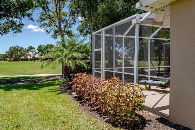 6659 Castlelawn Pl Unit 21, Naples, FL 34113 - view of side of home with a yard, stucco siding, and glass enclosure