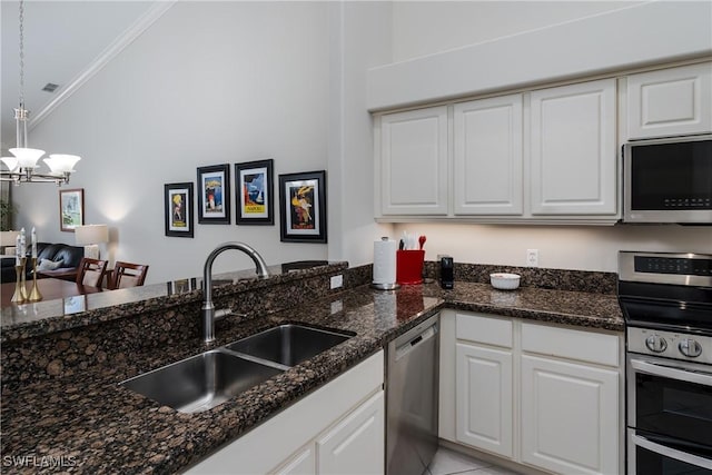 6659 Castlelawn Pl Unit 21, Naples, FL 34113 - kitchen featuring appliances with stainless steel finishes, a sink, ornamental molding, white cabinets, and a chandelier