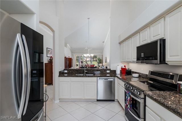 6659 Castlelawn Pl Unit 21, Naples, FL 34113 - kitchen with stainless steel appliances, a sink, light tile patterned floors, white cabinetry, and a peninsula