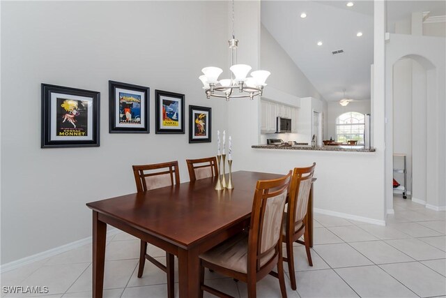 6659 Castlelawn Pl Unit 21, Naples, FL 34113 - dining space featuring a chandelier, high vaulted ceiling, light tile patterned flooring, recessed lighting, and baseboards
