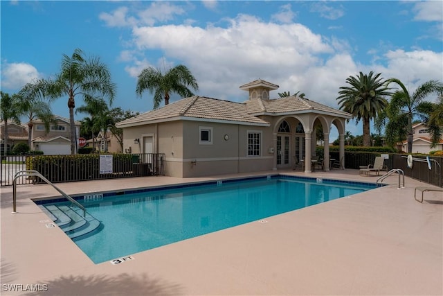 6659 Castlelawn Pl Unit 21, Naples, FL 34113 - community pool featuring french doors and a patio