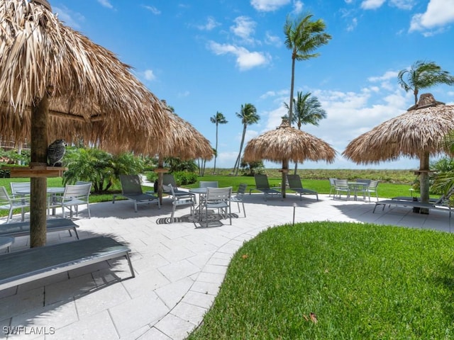 140 Seaview Ct Unit 206N, Marco Island, FL 34145 - view of home's community featuring outdoor dining area, a patio area, and a lawn