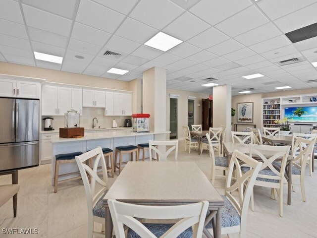 140 Seaview Ct Unit 206N, Marco Island, FL 34145 - dining room with a drop ceiling and built in shelves