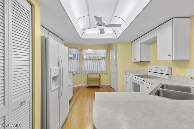 664 Wiggins Bay Dr, Naples, FL 34110 - kitchen with white appliances, a sink, a ceiling fan, light countertops, and white cabinetry