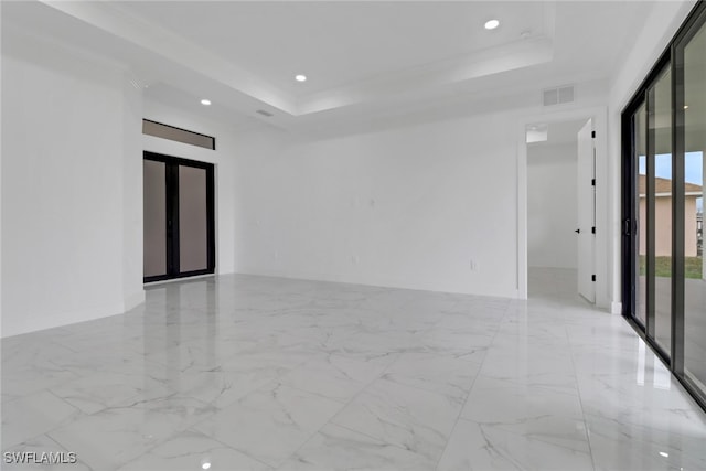2712 58th St W, Lehigh Acres, FL 33971 - unfurnished room featuring marble finish floors, a raised ceiling, and recessed lighting