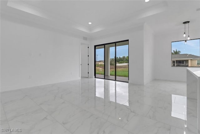 2712 58th St W, Lehigh Acres, FL 33971 - empty room featuring a raised ceiling, recessed lighting, and light marble finish floors