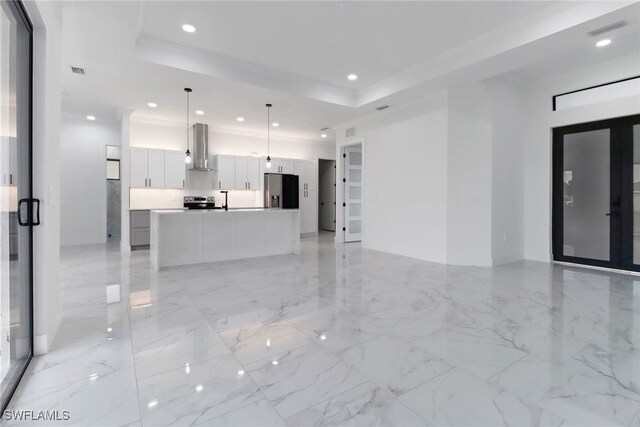 2712 58th St W, Lehigh Acres, FL 33971 - unfurnished living room featuring recessed lighting, a raised ceiling, and light marble finish floors