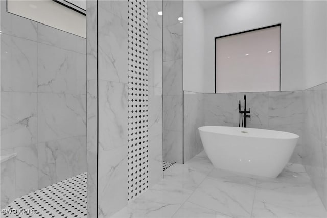 2712 58th St W, Lehigh Acres, FL 33971 - full bathroom featuring a marble finish shower, a freestanding tub, marble tiled floors, and tile walls