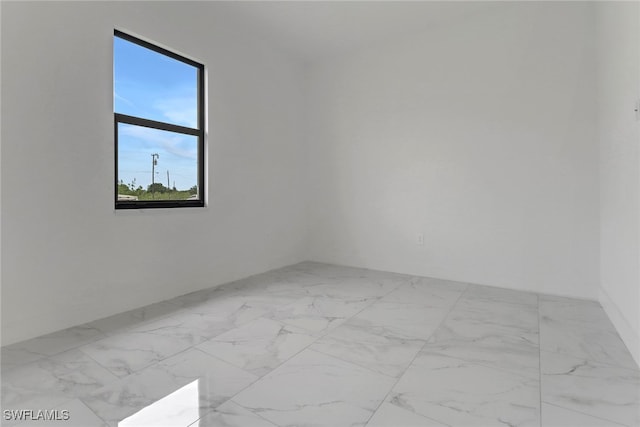 2712 58th St W, Lehigh Acres, FL 33971 - unfurnished room featuring marble look tile flooring
