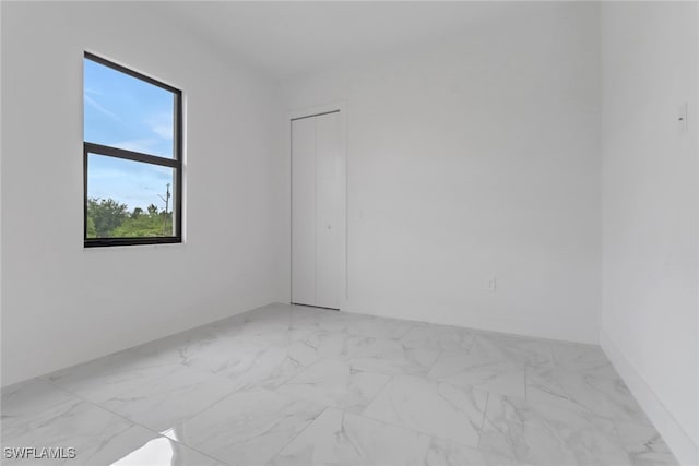 2712 58th St W, Lehigh Acres, FL 33971 - empty room featuring light marble finish floors